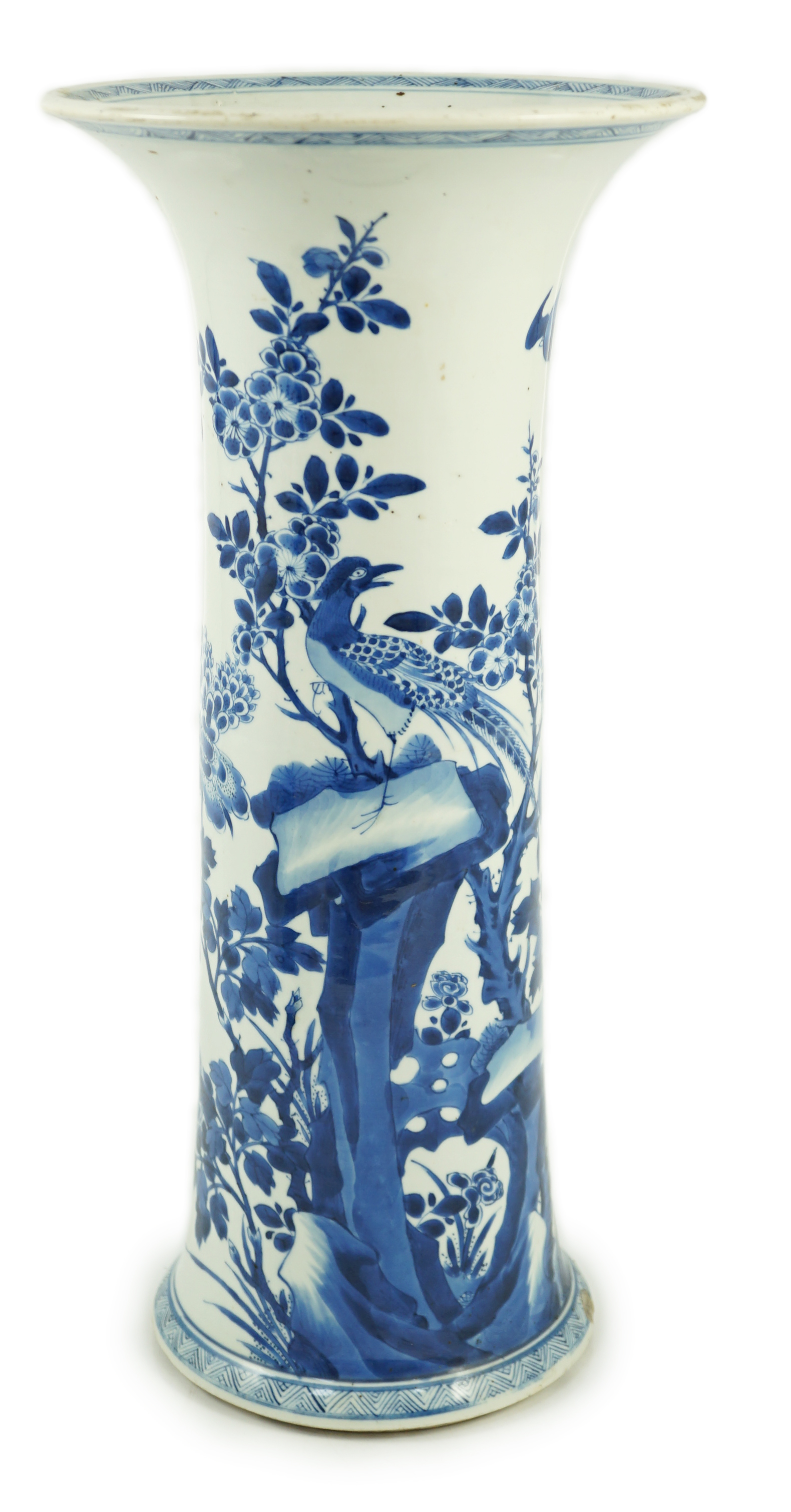 A tall Chinese blue and white ‘pheasants and rocks’ beaker vase, gu, Kangxi period, minor faults